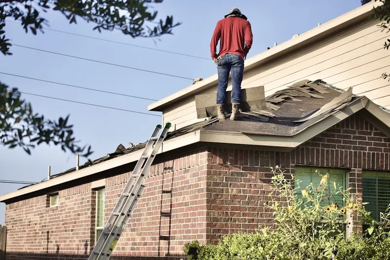 Professional roofer working on a residential roof in Sturtevant